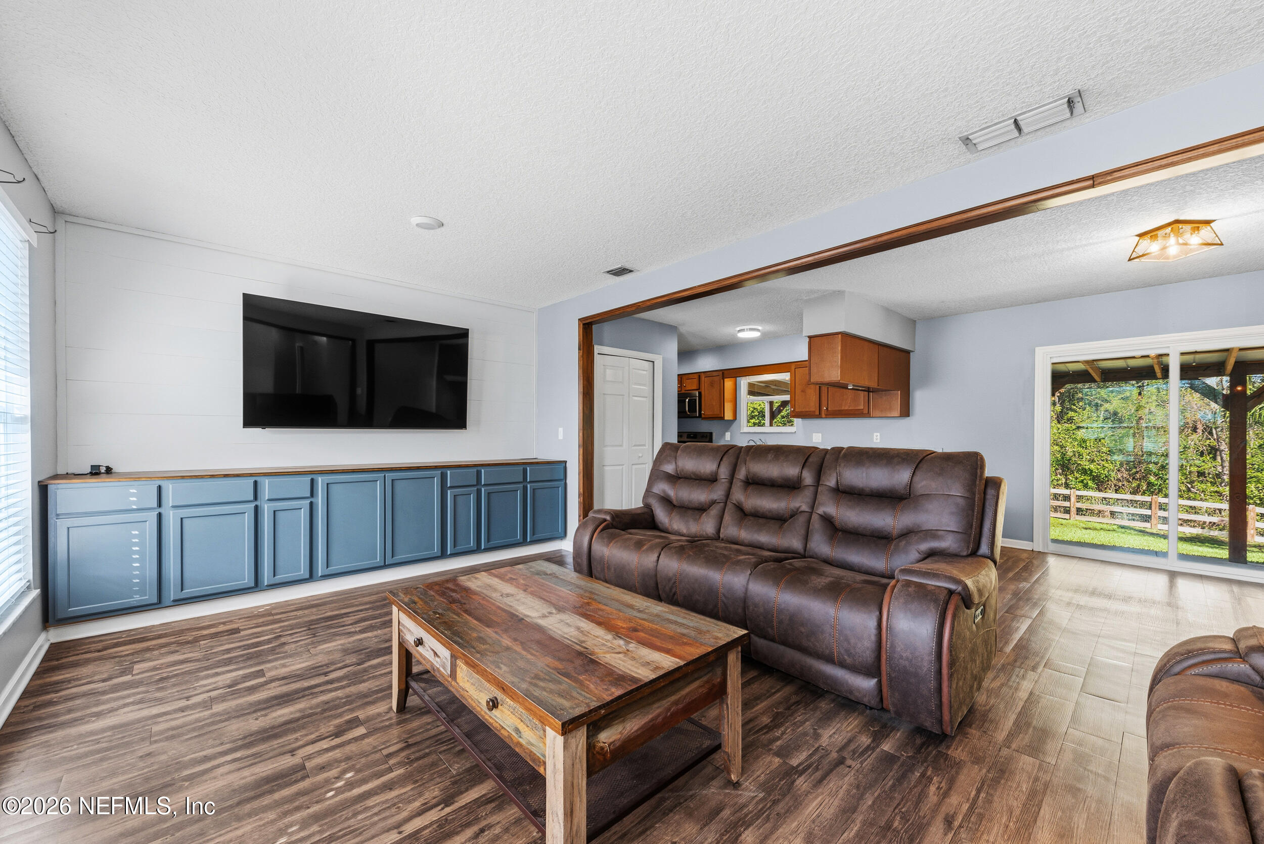 8729 Pinon Drive Jacksonville, FL 32221 - Photo 8 of 33 a living room with furniture and a flat screen tv