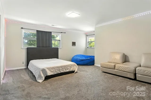 a spacious bedroom with a bed and window