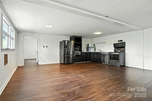 a view of a kitchen with a sink and a refrigerator