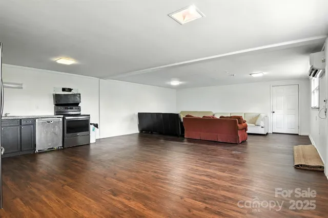 a large kitchen with stainless steel appliances a large counter top
