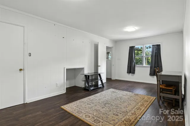 an entryway at living room with fireplace and rug