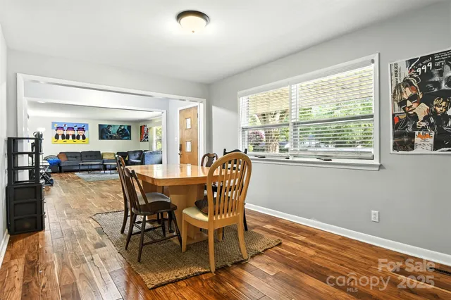a dining room with furniture and wooden floor