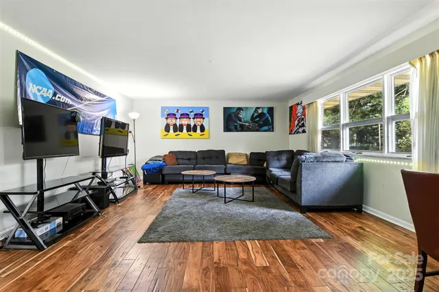 a living room with furniture a rug and a flat screen tv