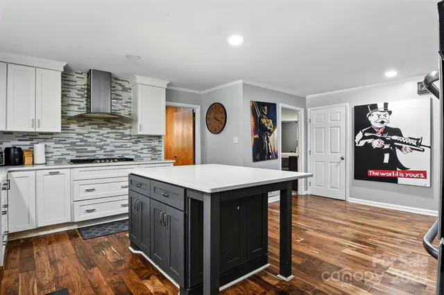 a kitchen with a sink cabinets and wooden floor