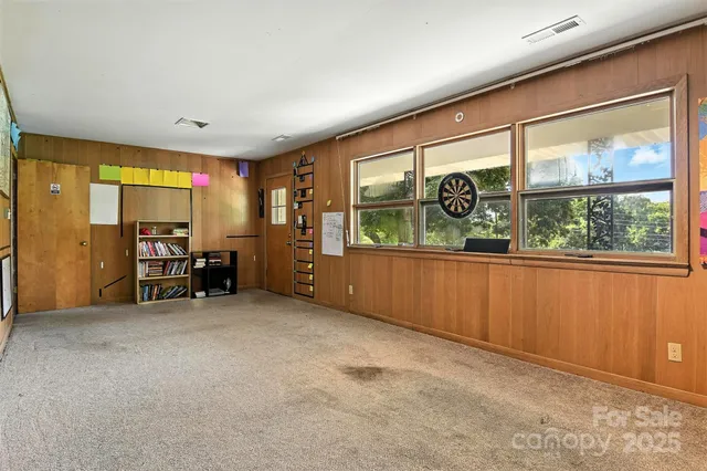 a kitchen with stainless steel appliances and wooden floor