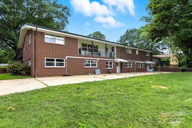 a front view of a house with yard porch and furniture