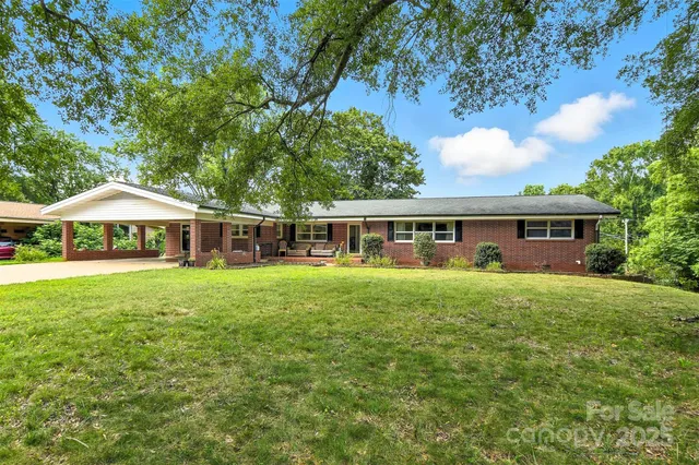 a front view of a house with yard and green space