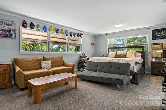 a bedroom with furniture and a large window