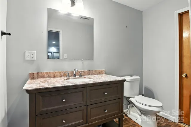a bathroom with a sink toilet and mirror