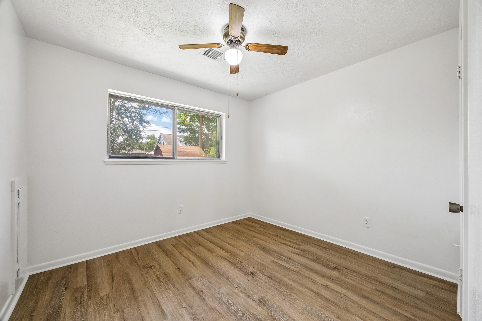 4903 Mistletoe Road Pasadena, TX 77505 - Photo 7 of 10 a view of empty room with wooden floor and fan