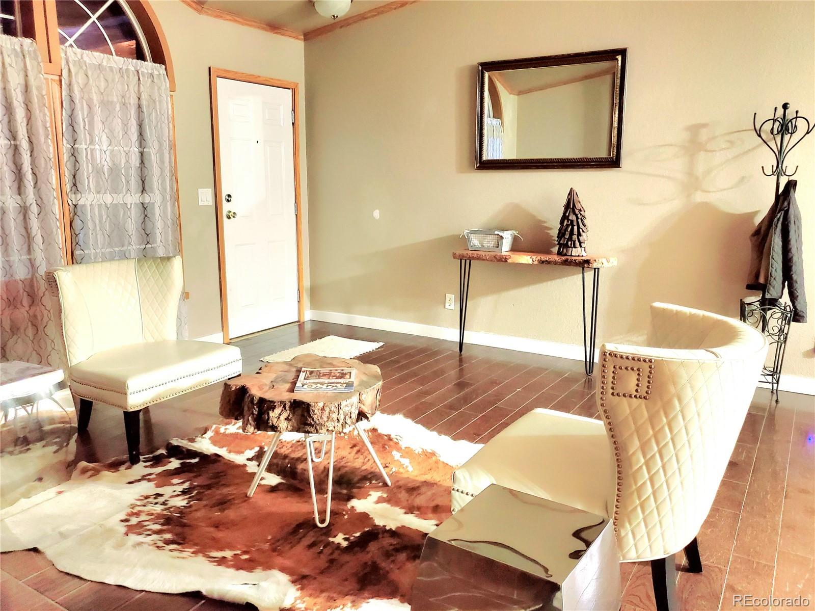 5339 County Road 19 Florence, CO 81226 - Photo 13 of 50 a living room with furniture and a potted plant