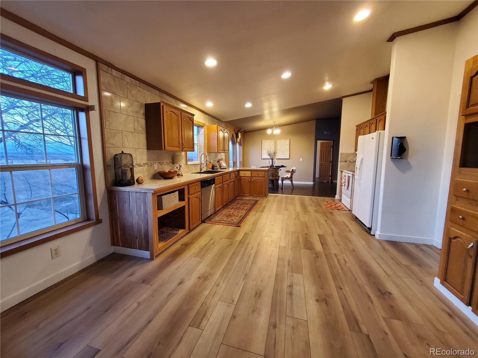 5339 County Road 19 Florence, CO 81226 - Photo 20 of 50 a large kitchen with a lot of counter space and a wooden floor
