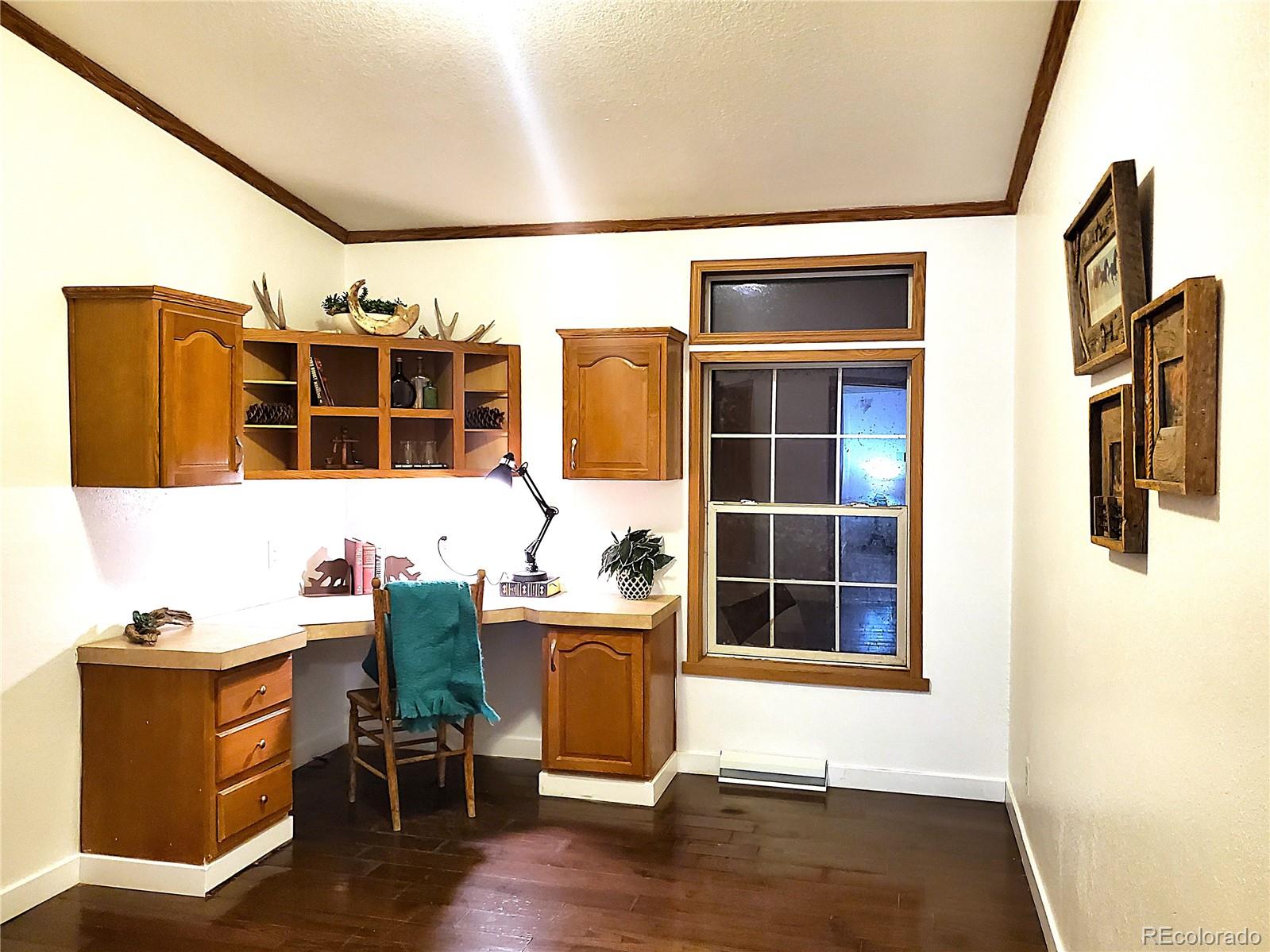 5339 County Road 19 Florence, CO 81226 - Photo 27 of 50 a room with table chair and wooden floor