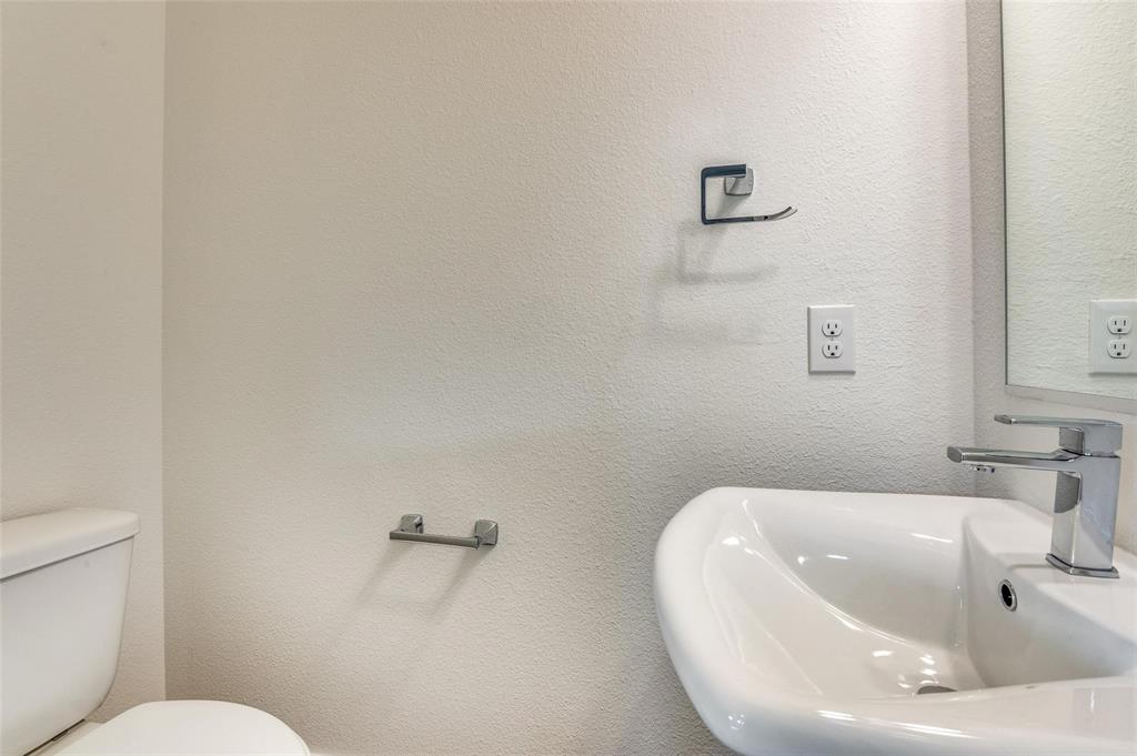 7307 Rubio Place Dallas, TX 75235 - Photo 16 of 17 a bathroom with a toilet and a sink