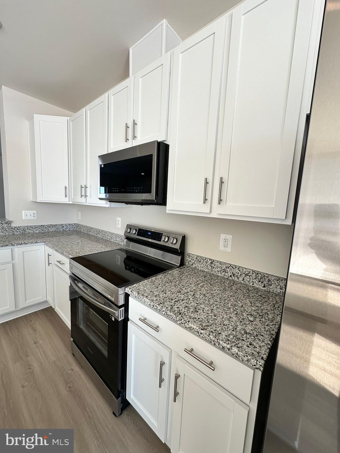 41 Sherman Avenue Ranson, WV 25438 - Photo 11 of 19 a kitchen with granite countertop a sink and a stove top oven