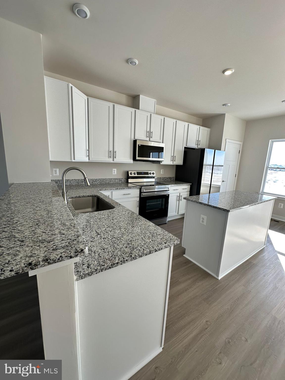 41 Sherman Avenue Ranson, WV 25438 - Photo 12 of 19 a kitchen with stainless steel appliances granite countertop a sink dishwasher a refrigerator a microwave oven with granite countertops and cabinets