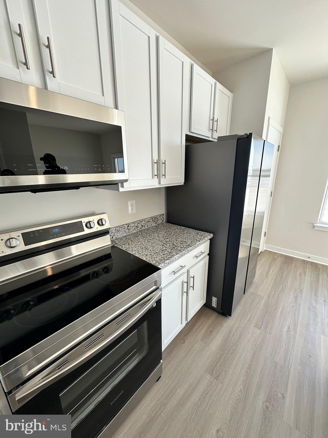 41 Sherman Avenue Ranson, WV 25438 - Photo 13 of 19 a kitchen with wooden cabinets and a stove top oven