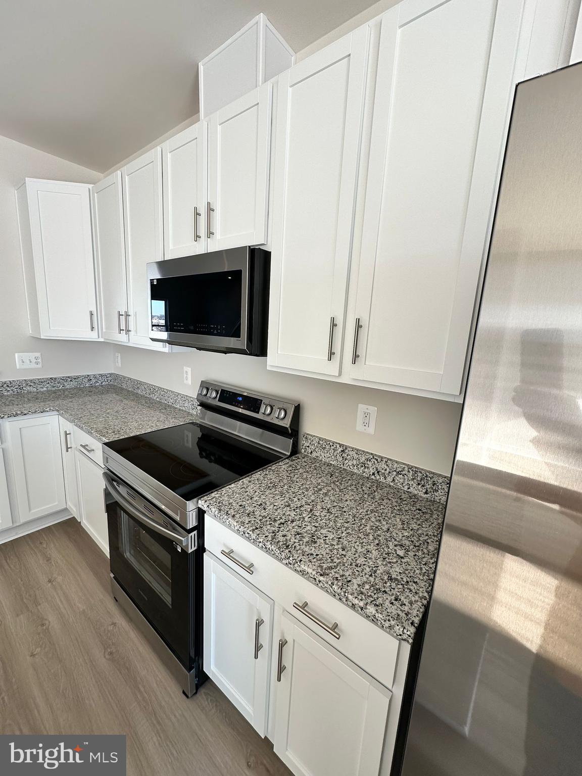 41 Sherman Avenue Ranson, WV 25438 - Photo 14 of 19 a kitchen with white cabinets and appliances