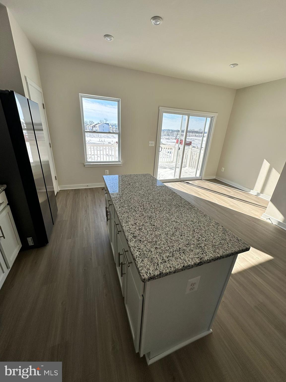 41 Sherman Avenue Ranson, WV 25438 - Photo 17 of 19 a room with kitchen island granite countertop wooden floors
