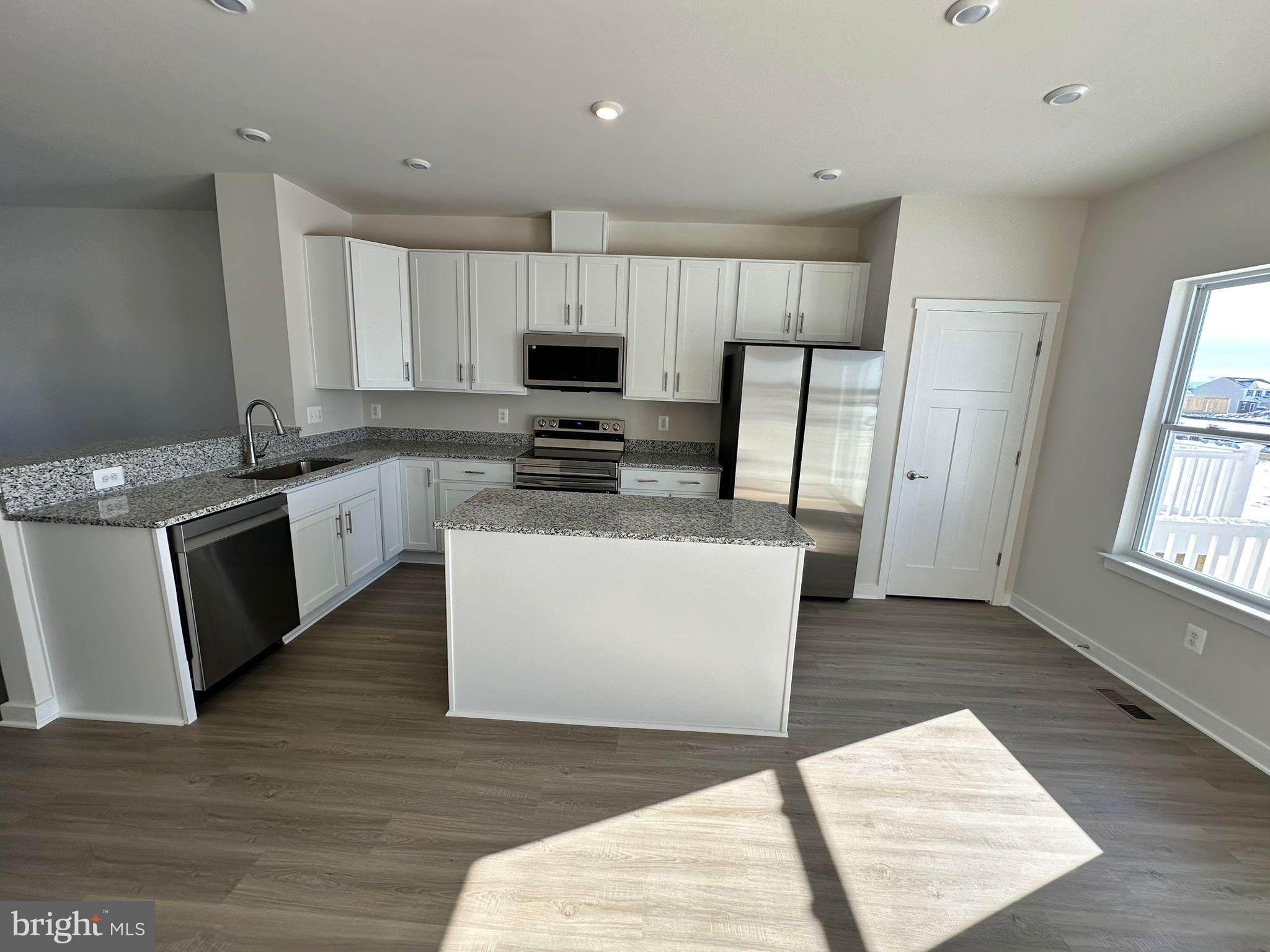 41 Sherman Avenue Ranson, WV 25438 - Photo 6 of 19 a large kitchen with stainless steel appliances granite countertop a stove a sink dishwasher and a refrigerator