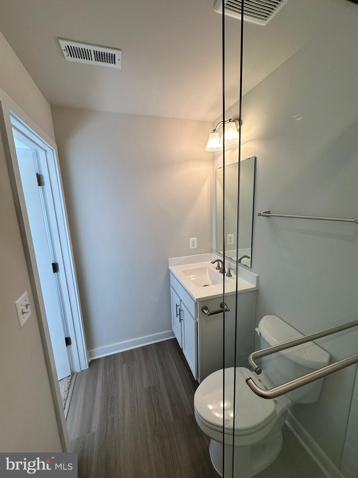 41 Sherman Avenue Ranson, WV 25438 - Photo 7 of 19 a bathroom with a sink a toilet a mirror and shower