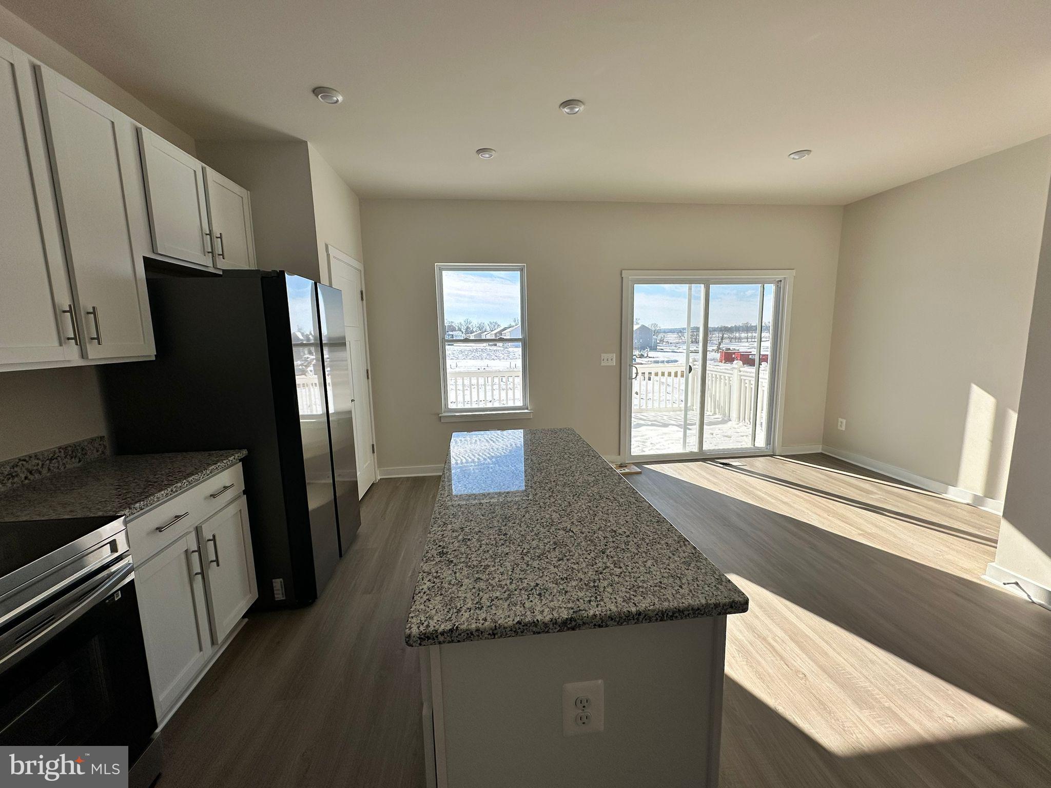 41 Sherman Avenue Ranson, WV 25438 - Photo 10 of 19 a kitchen with stainless steel appliances granite countertop a sink and a refrigerator