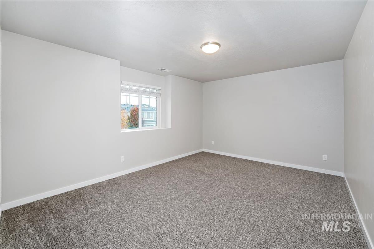 4585 West Everest Street Meridian, ID 83646 - Photo 26 of 37 Carpeted spare room featuring baseboards