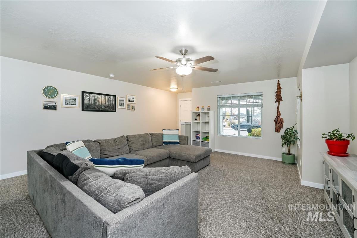 4585 West Everest Street Meridian, ID 83646 - Photo 5 of 37 Living area with carpet flooring and ceiling fan