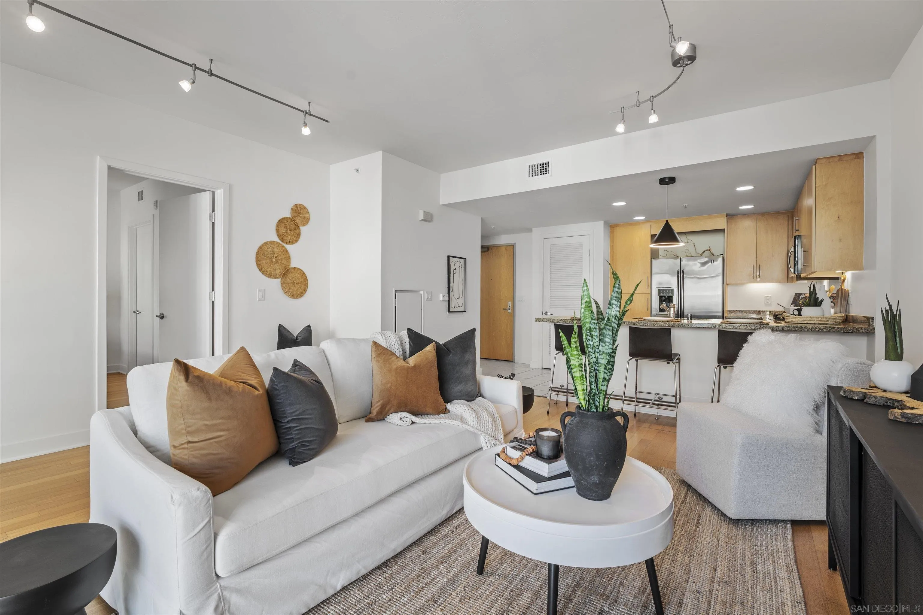 3812 Park Boulevard, Unit 412 San Diego, CA 92103 - Photo 4 of 24 a living room with furniture kitchen view and a table