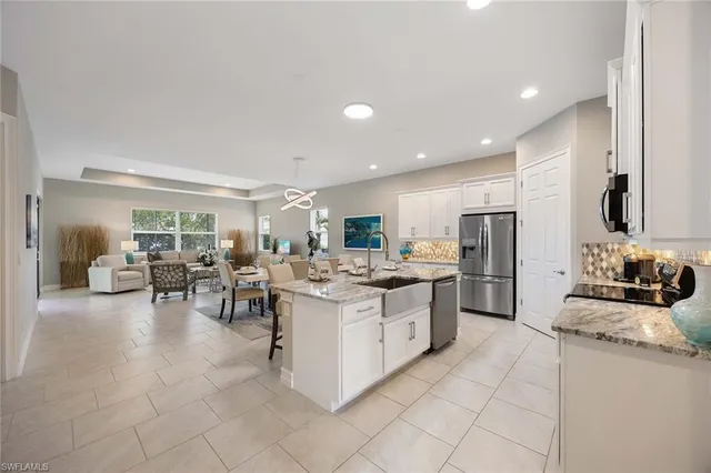 a kitchen with lots of counter top space and stainless steel appliances