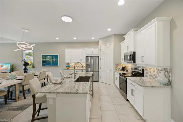 a kitchen with stainless steel appliances kitchen island granite countertop a sink and cabinets
