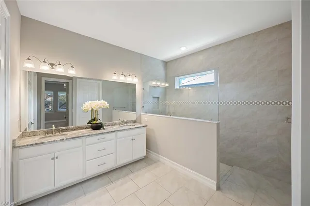 a bathroom with a double vanity sink and a mirror