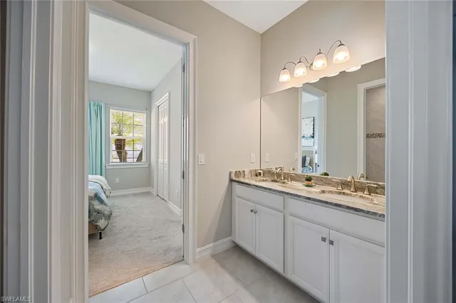 a bathroom with a double vanity sink and a mirror