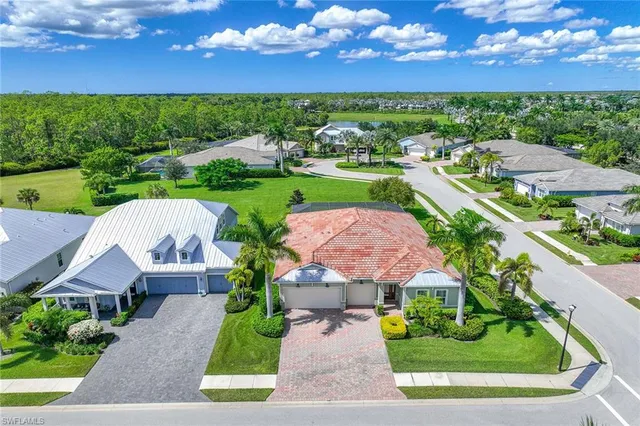 an aerial view of a house with a garden and lake view