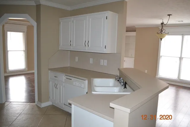 a kitchen with a sink cabinets and window