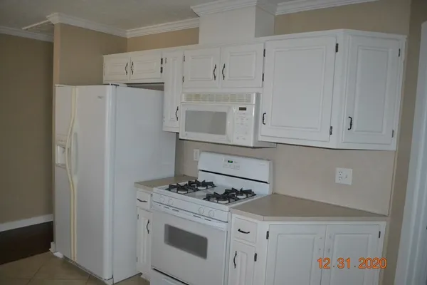a kitchen with cabinets and a stove