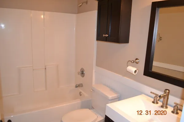 a bathroom with a sink a toilet and bathtub