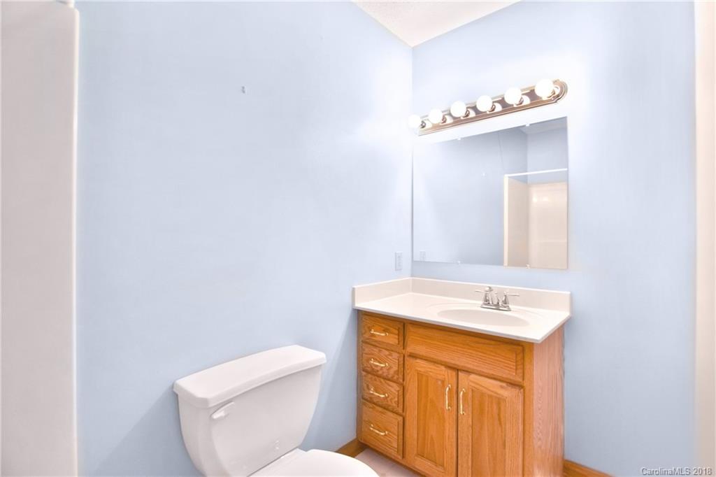6290 Stokes Ferry Road Salisbury, NC 28146 - Photo 16 of 28 a bathroom with a sink mirror and toilet