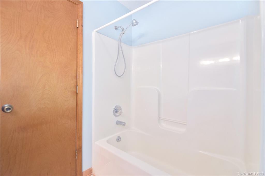 6290 Stokes Ferry Road Salisbury, NC 28146 - Photo 17 of 28 a bathroom with a bathtub and a shower