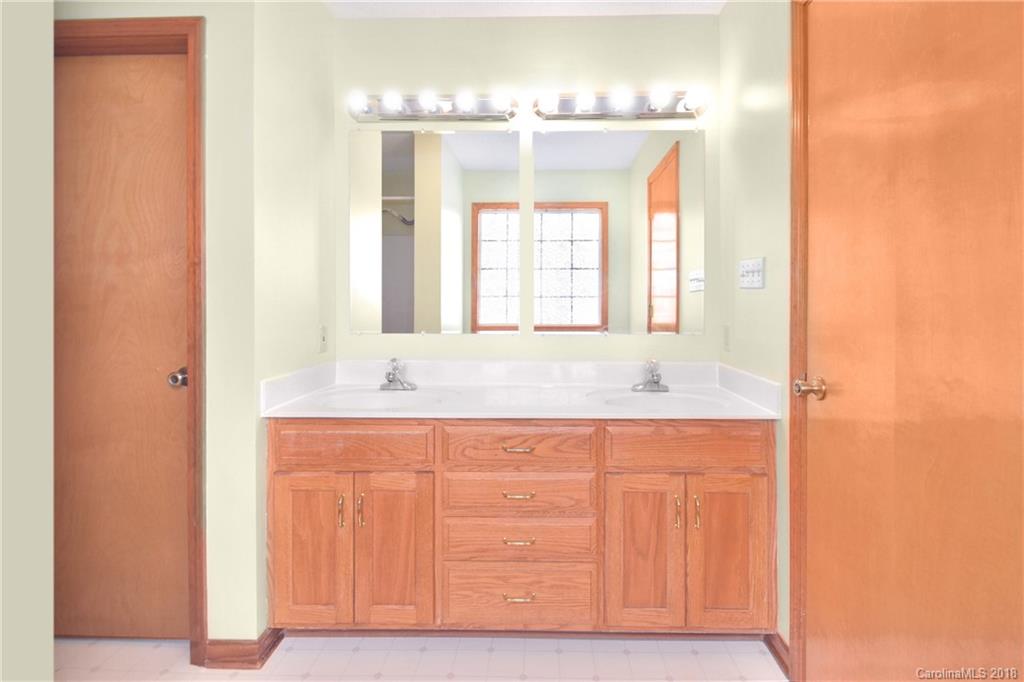 6290 Stokes Ferry Road Salisbury, NC 28146 - Photo 19 of 28 a bathroom with a double vanity sink and a mirror