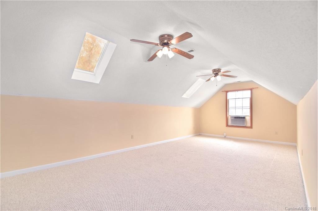 6290 Stokes Ferry Road Salisbury, NC 28146 - Photo 23 of 28 an empty room with windows and fan