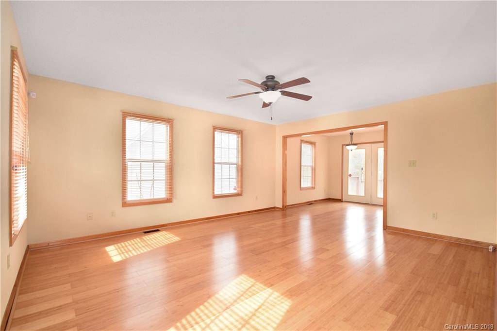 6290 Stokes Ferry Road Salisbury, NC 28146 - Photo 6 of 28 a view of an empty room with a window and wooden floor