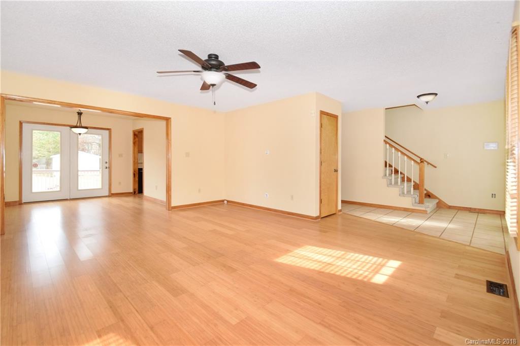 6290 Stokes Ferry Road Salisbury, NC 28146 - Photo 7 of 28 a view of a livingroom with wooden floor and a ceiling fan