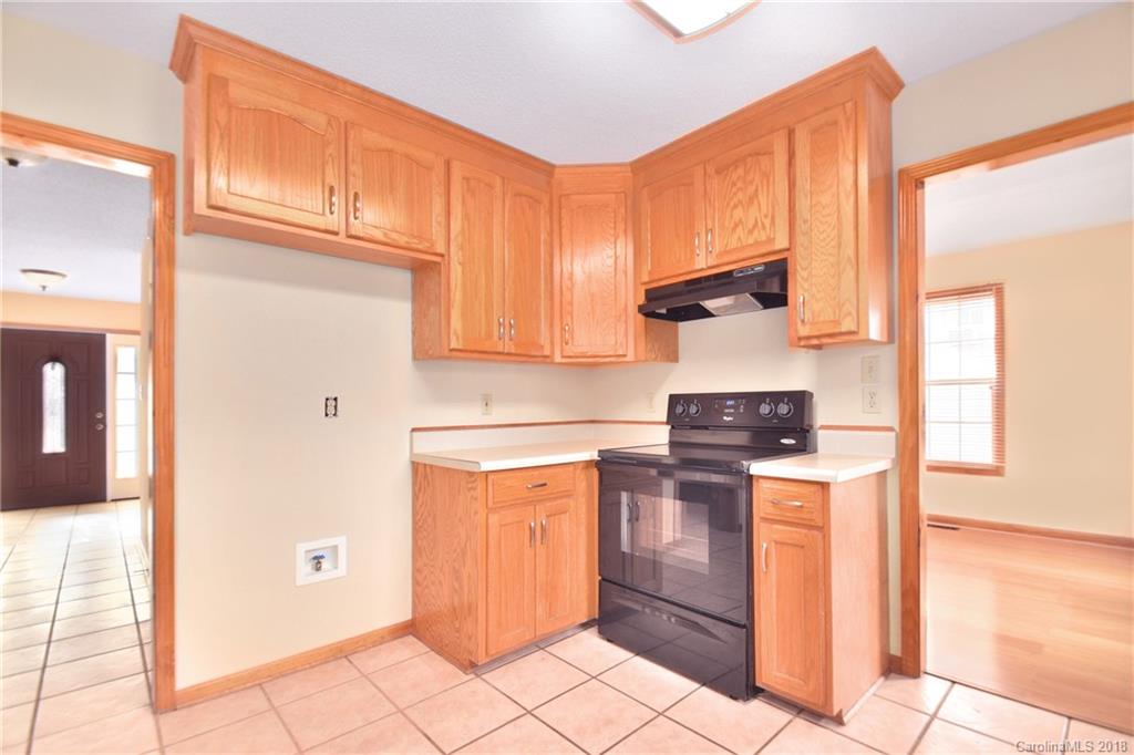6290 Stokes Ferry Road Salisbury, NC 28146 - Photo 10 of 28 a kitchen with stainless steel appliances granite countertop a refrigerator and a stove