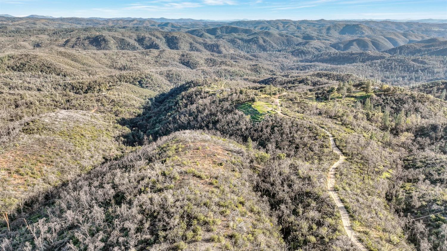10263 Ham Luddy Road Mountain Ranch, CA 95246 - Photo 26 of 31 a view of a dry field with mountains in the background