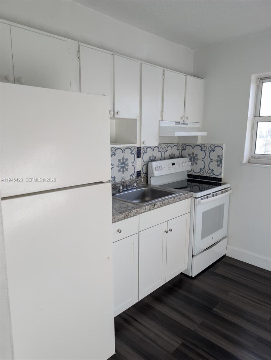 1461 Southwest 5th Street, Unit 5 Miami, FL 33135 - Photo 11 of 16 a kitchen with white cabinets and white appliances