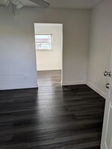 a view of room with wooden floor