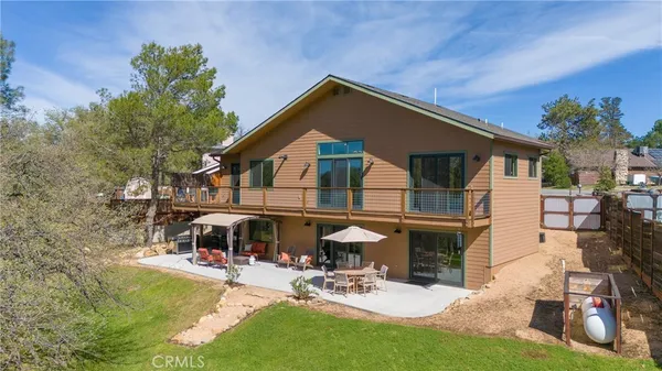 a view of a house with backyard porch and sitting area