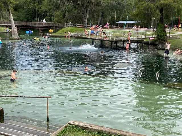 a view of swimming pool with sitting area