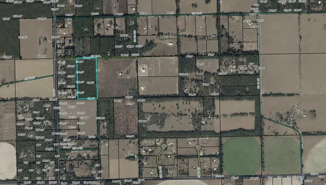 an aerial view of a houses with outdoor space